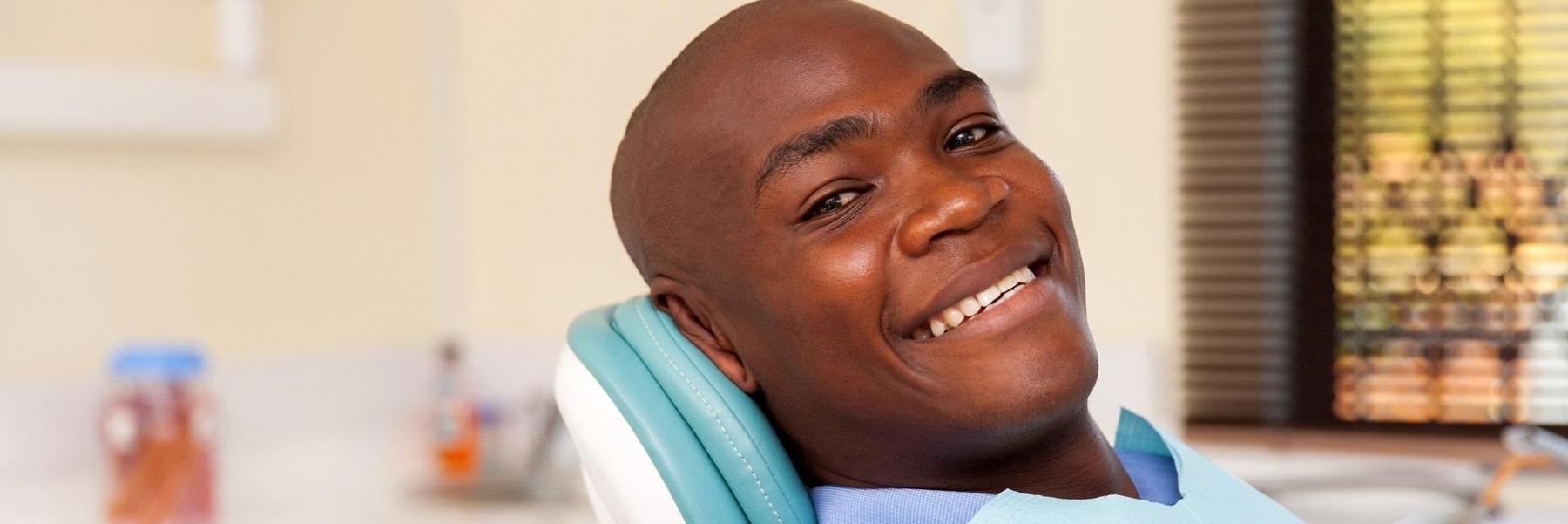 Man sitting in dental exam before check up in Edina, MN