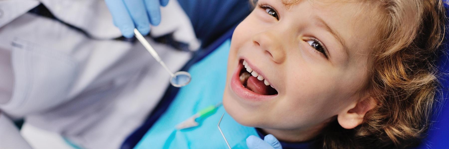Young girl smiling during dental examination in Edina, MN