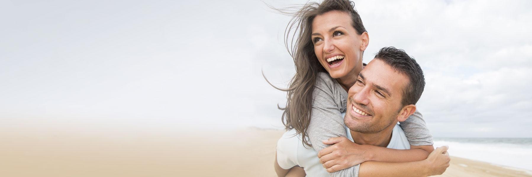 Happy couple playing after gum disease treatment in Edina, MN