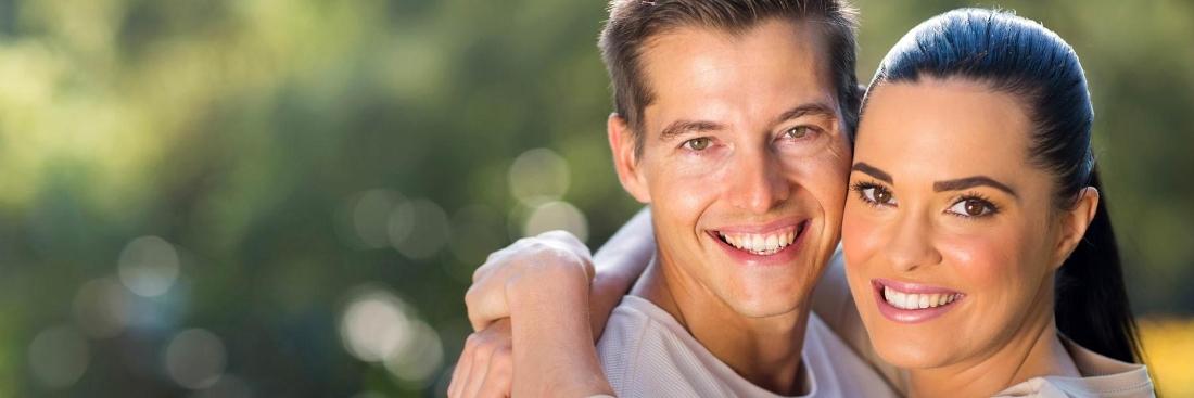 Younger couple smiling after professional teeth whitening in Edina, MN