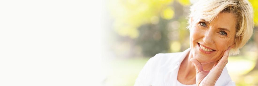 Older woman smiling after dental treatment in Edina, MN