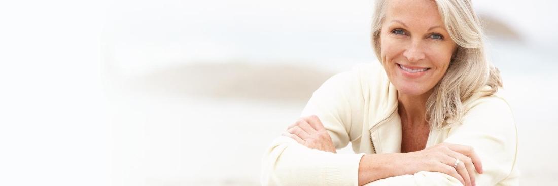 Older woman smiling after getting dentures in Edina, MN 