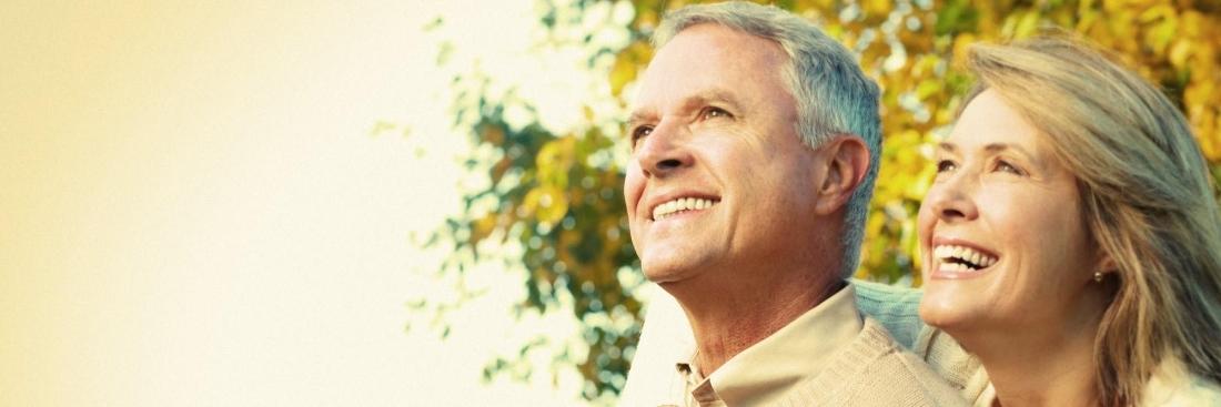 Couple smiling after getting dental implants in Edina, MN
