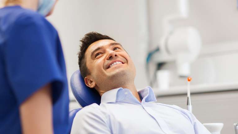 Man smiling during professional dental cleaning in Edina, MN
