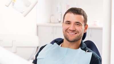 Man relaxing before dental examination in Edina, MN