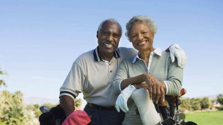 Couple smiling after getting dental implants in Edina, MN