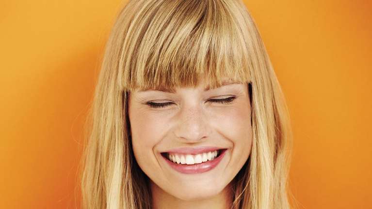 Lady smiling after cosmetic dentistry session in Edina, MN