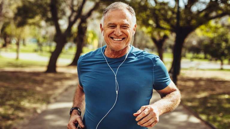 Man jogging happily after getting dental crowns in Edina, MN