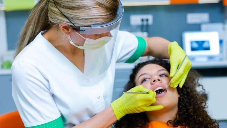 Lady undergoing dental cleaning in Edina, MN