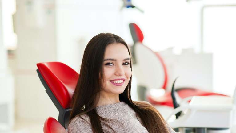 A woman wiht Precisely and Efficiently Placed Dental Implants in Edina, MN