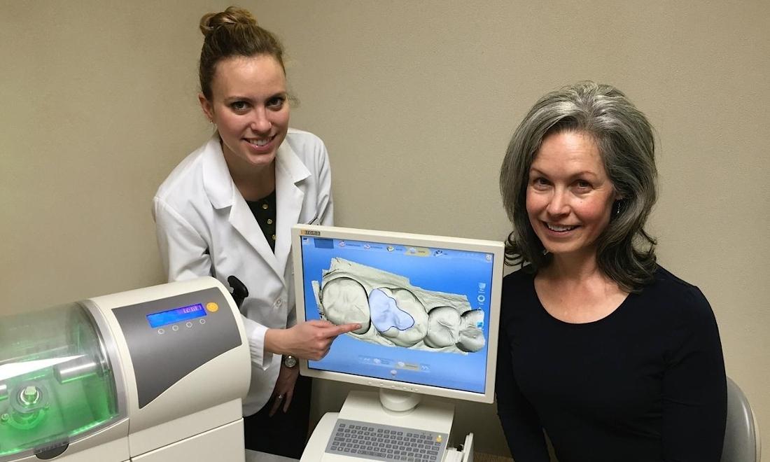 image of Dr. Holm assisting patient with modern technology for better diagnostics